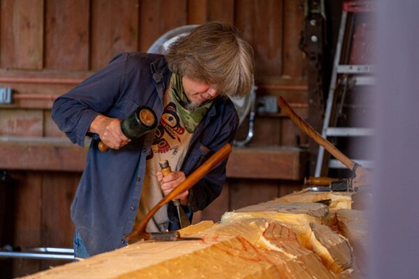 Tommy Joseph workinng on carving a totem pole in Sitka National Historical Park